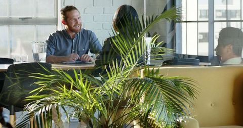 Enthusiastic Business Meeting in Modern Office with Diverse Colleagues