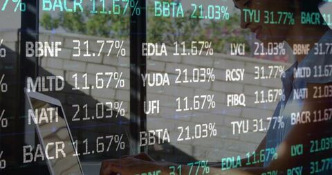 Businesswoman analyzing data with laptop and overlayed financial statistics