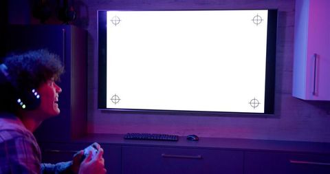 Gamer enjoying console with headphones in modern living room