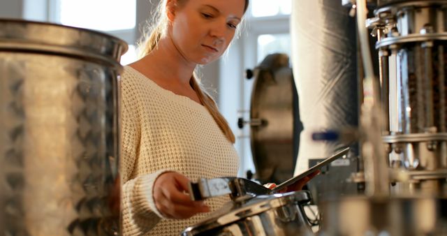 Woman Working in Craft Brewery Carefully Inspecting Equipments - Download Free Stock Images Pikwizard.com