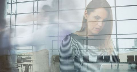 Woman Focusing on Work Amidst Busy Commute