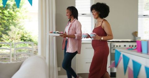 Women Preparing for Baby Shower Party in Living Room