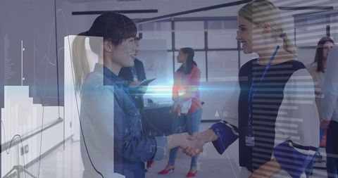 Professional Women Shaking Hands in Modern Business Environment