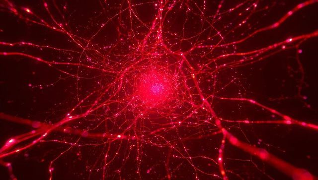 Pulsing red neural network core with glowing filaments and microscopic luminous nodes