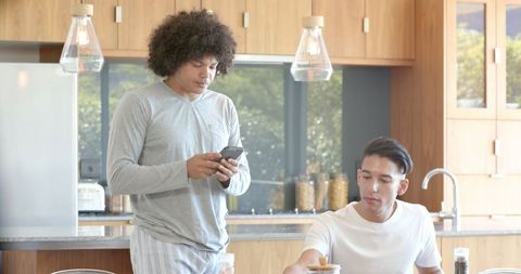 Diverse Friends Interacting in Modern Kitchen Lifestyle