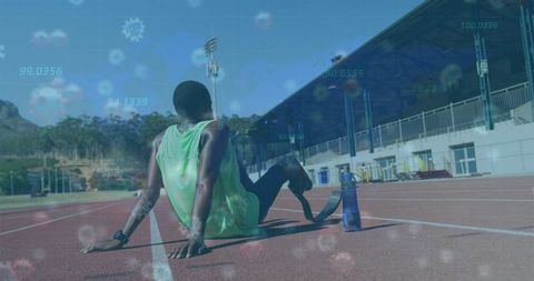 Athlete resting on track with digital overlay