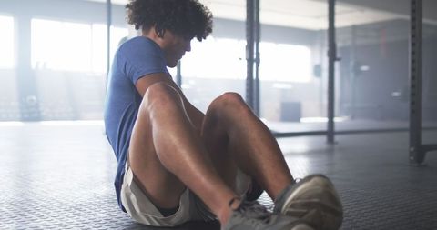 Man Exercising with Medicine Ball in Gym Focused on Fitness
