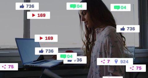 Woman reading notebook at desk with laptop and floating social media notification icons