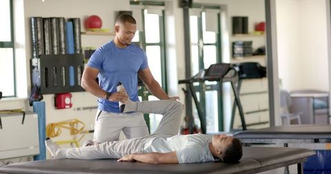 Physical Therapist Assisting Patient During Rehabilitation in Clinic