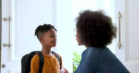 Mother encouraging multiracial child before school