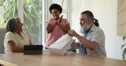 Joyful moment as senior couple receives gift from excited visitor