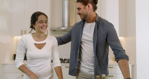 Smiling Couple Preparing Vegetables in Modern Kitchen