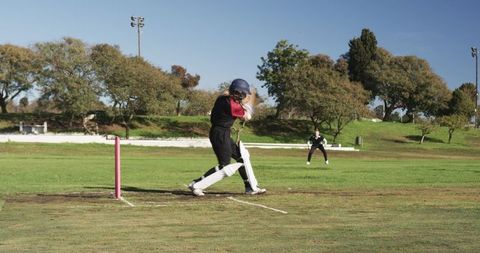 Female Cricketer Batting in Competitive Match on Community Ground
