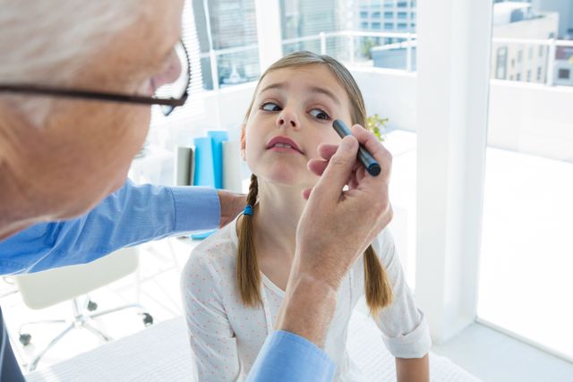 Doctor Examining Young Girl's Eye in Modern Clinic - Download Free Stock Photos Pikwizard.com