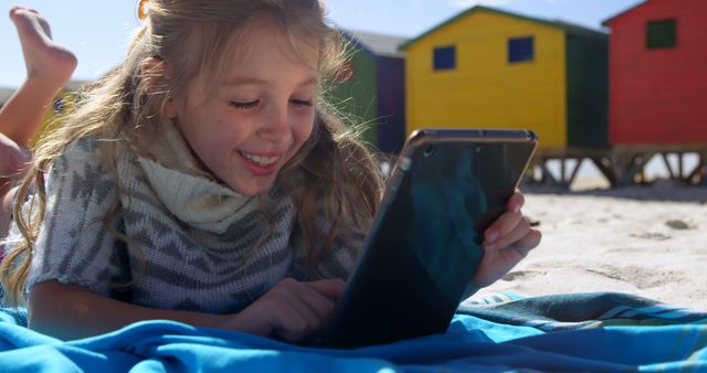 Happy Girl Using Tablet on Beach with Colorful Cabins - Download Free Stock Images Pikwizard.com