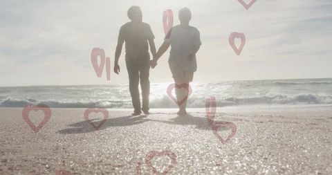 Romantic Senior Couple Walking on Scenic Sandy Beach at Sunset