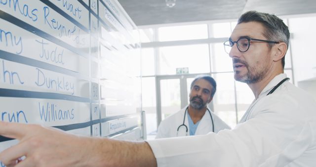 Doctors Discussing Patient List in Hospital - Download Free Stock Images Pikwizard.com