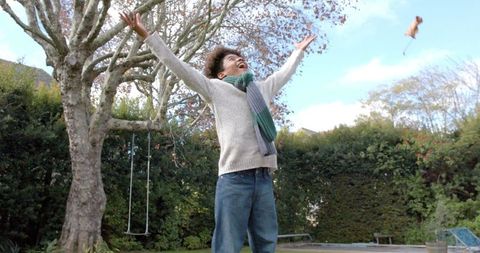 Boy Joyfully Tossing Leaves in Autumn Garden - Download Free Stock Images Pikwizard.com