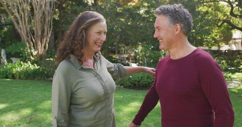 Happy Senior Couple Embracing in Lush Garden