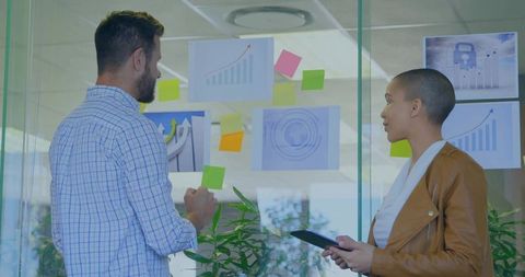 Office Professionals Analyzing Charts for Business Strategy Collaboration