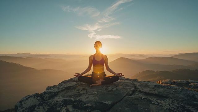 Woman Meditating on Mountain Peak Bask in Sunrise Serenity