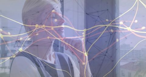 Senior executive contemplating strategic data analysis by window