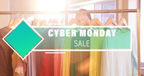 Cyber monday sale displaying bold overlay on colorful clothing rack backlit by sunlight