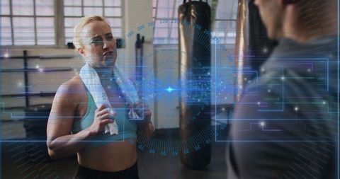 Athletic Woman with Towel in High-Tech Gym Environment