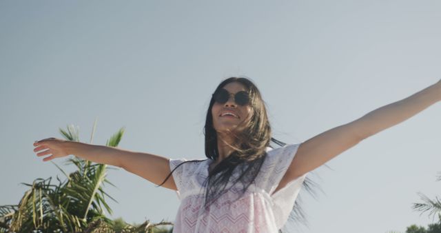 Smiling Woman Enjoying Sun with Open Arms on Beach - Download Free Stock Images Pikwizard.com