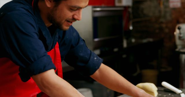 Chef Working in Kitchen Kneading Dough with Smile - Download Free Stock Images Pikwizard.com