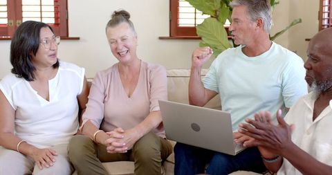 Diverse Group of Friends Enjoying Time Together on a Cozy Sofa