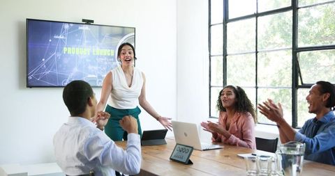 Diverse Team Celebrating Successful Product Launch Presentation