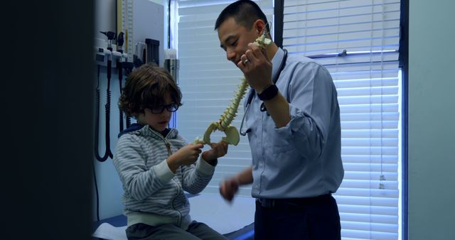 Doctor Explaining Spine Model to Young Boy at Medical Clinic - Download Free Stock Images Pikwizard.com