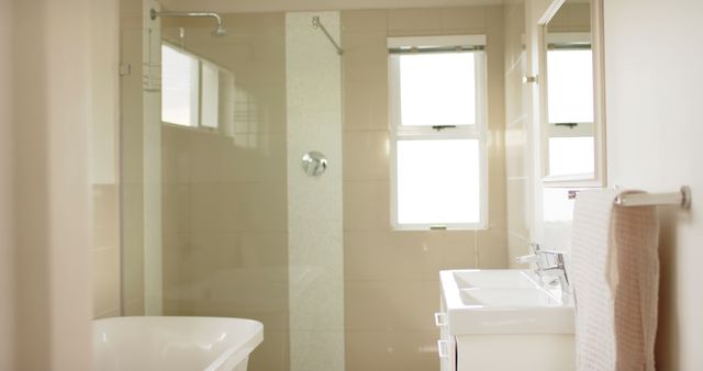 Modern bright bathroom with big window, bathtub and shower. Interior design, home and domestic life.