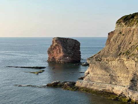 Majestic coastal beach rock formations at dawn