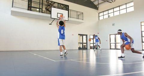 African american basketball team practicing on indoor court