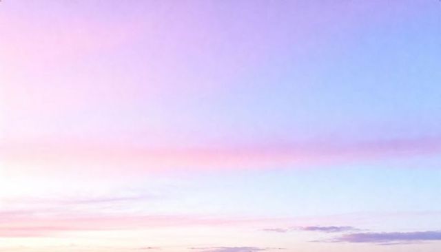 Tranquil pastel sunrise sky gradients glowing over calm horizon with wispy cirrus clouds