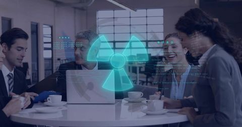 Business team reviewing holographic radiation hazard symbol over laptop during modern meeting