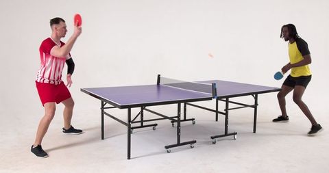 Dynamic table tennis match amid enthusiastic players