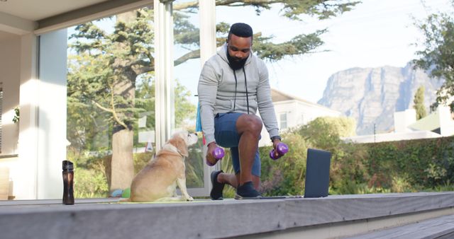 Man Exercising with Dumbbells at Home While Dog Watches - Download Free Stock Images Pikwizard.com