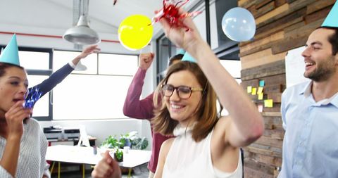 Joyful business professionals celebrating in office party
