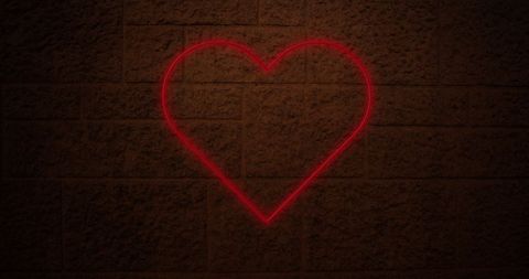 Radiant Neon Heart on Dark Brick Wall
