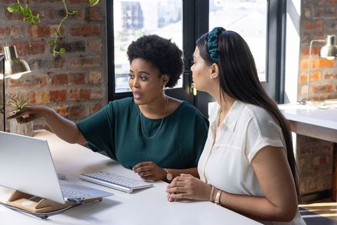 Diverse Female Coworkers Collaborating on Business Project in Modern Office
