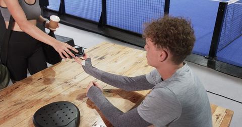 Friends at Padel Court Reception Interacting and Bonding Over Coffee