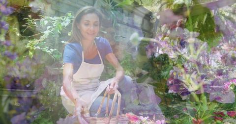 Woman gathering potted plants in community garden outdoors