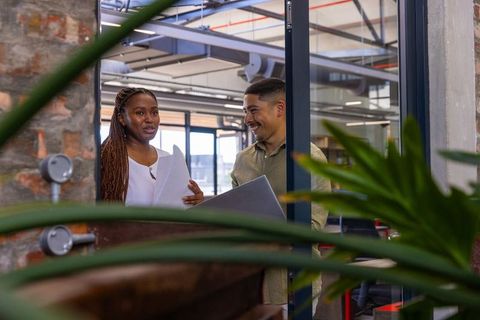 Diverse colleagues discussing documents in modern office