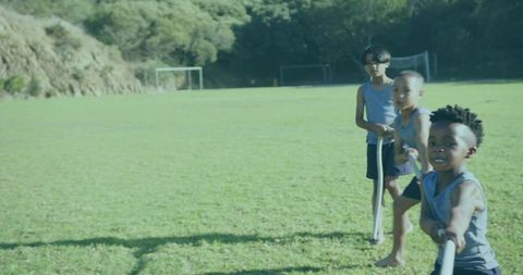 Children Playing Tug-of-War in Sunny Field