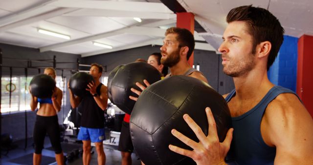 Group Fitness Class Using Medicine Balls for Strength Training - Download Free Stock Images Pikwizard.com