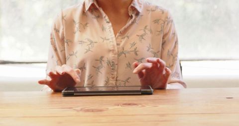 Woman Interacting with Tablet at Wooden Desk in Bright Office - Download Free Stock Images Pikwizard.com