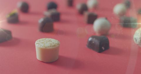 assorted chocolate pralines on red background with light effects - Download Free Stock Images Pikwizard.com